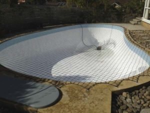 Pool Safety Net can be fitted to an empty pool.  This is a black net.