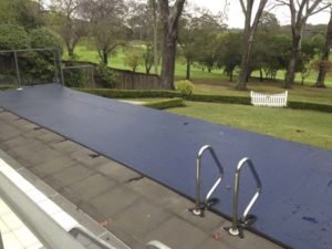 Leaf cover on wet edge pool with ladder