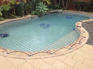 Pool Safety Net on free-form pool with rock feature