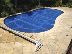 Solar blanket & C-Frame roller on gorgeous pool