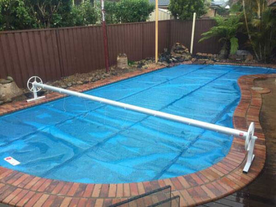 Solar covers & rollers on pool, providing efficient pool heating and protection in Melbourne